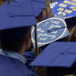 caps at graduation: one reads "well I guess this is growing up"