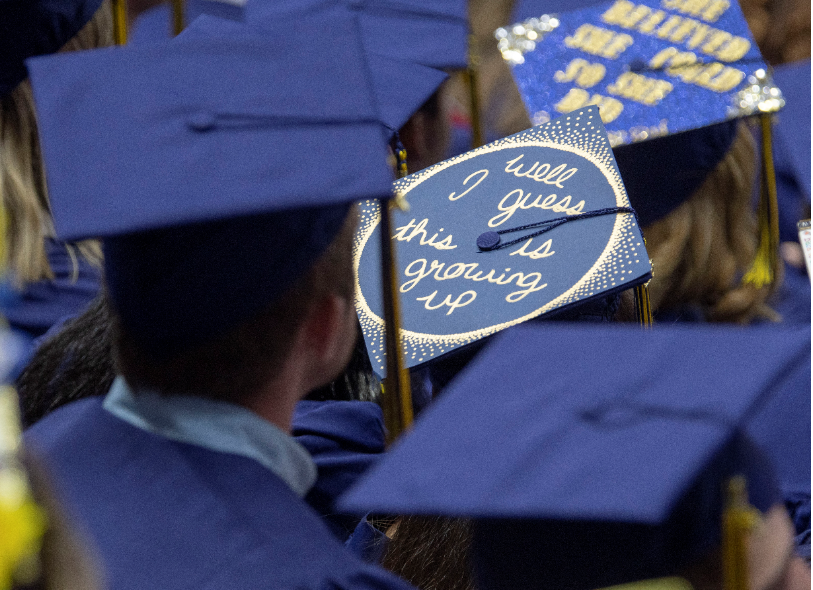 caps at graduation: one reads "well I guess this is growing up"